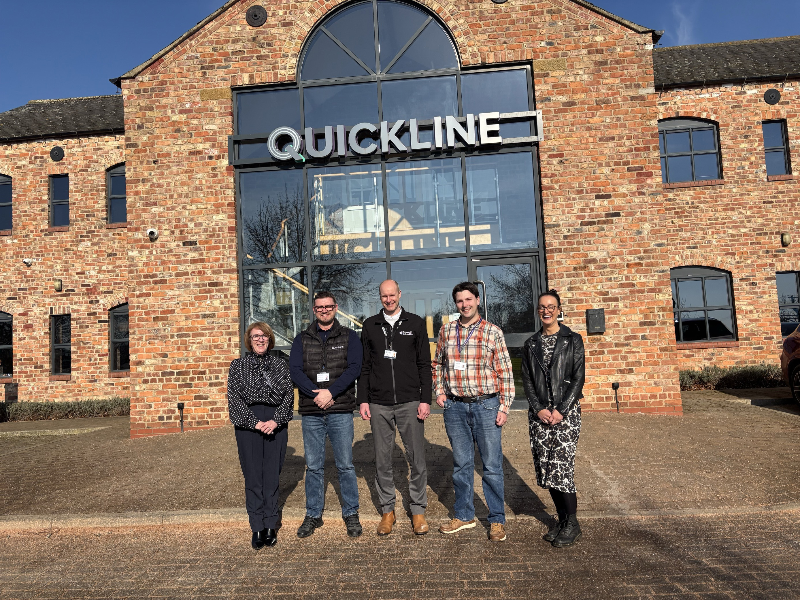 Quickline and Sewell FM representatives outside Quicklines headquarters
