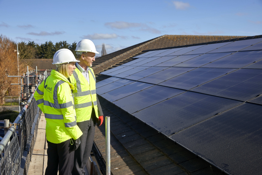 Representatives from Sewell FM and Citycare examine new PV panels